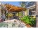 Backyard oasis features a wooden pergola, hot tub, outdoor seating, and lush greenery for relaxation and enjoyment at 109 Burney Rd, Osprey, FL 34229