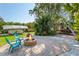 Inviting backyard offers a firepit, outdoor seating, lush landscaping, and a trailer covered by a canopy at 109 Burney Rd, Osprey, FL 34229