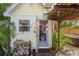 Outdoor shed with an open door, wood pile, and a nearby hot tub surrounded by lush greenery at 109 Burney Rd, Osprey, FL 34229