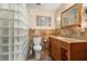 Well-lit bathroom with a glass block shower and a wooden vanity at 109 Burney Rd, Osprey, FL 34229