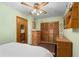 Bedroom featuring light green walls, a ceiling fan, a closet, and neutral decor at 109 Burney Rd, Osprey, FL 34229