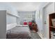 Cozy bedroom with a built in Murphy bed, desk, and a vibrant area rug at 109 Burney Rd, Osprey, FL 34229