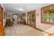 Open dining area featuring tile floors and wood-framed windows with deck access at 109 Burney Rd, Osprey, FL 34229