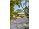 Cozy fire pit area with Adirondack chairs and lush landscaping, creating a serene outdoor gathering space at 109 Burney Rd, Osprey, FL 34229