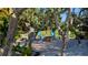 Inviting outdoor fire pit area featuring a brick surround, patio, string lights, and comfortable Adirondack chairs at 109 Burney Rd, Osprey, FL 34229