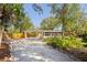 Exterior view of the home highlighting the landscaping and outdoor space at 109 Burney Rd, Osprey, FL 34229