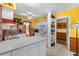 Kitchen featuring white cabinets, neutral counters, and yellow walls. Vintage details add charm to the space at 109 Burney Rd, Osprey, FL 34229