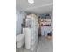 Bright laundry room with glass block partition, toilet, shelving, and easy access at 109 Burney Rd, Osprey, FL 34229