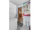 Clean laundry room featuring stacked washer and dryer and built-in shelving at 109 Burney Rd, Osprey, FL 34229