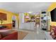Open living space featuring yellow walls, white cabinets, and a door to the backyard patio at 109 Burney Rd, Osprey, FL 34229