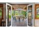 Charming outdoor dining space with a wooden deck and shaded seating area at 109 Burney Rd, Osprey, FL 34229