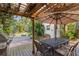 Outdoor patio boasts a dining set, grill, and a firepit in a landscaped backyard, perfect for entertainment at 109 Burney Rd, Osprey, FL 34229