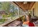 Enclosed patio featuring a fire pit, wood ceiling, and a lovely view of the landscaped backyard at 109 Burney Rd, Osprey, FL 34229