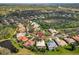 Aerial view of the neighborhood with tree coverage and nearby ponds at 1106 Brambling Ct, Bradenton, FL 34212