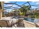 Stunning screened-in pool area, complete with lounge chairs and lush tropical landscaping at 1106 Brambling Ct, Bradenton, FL 34212