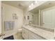 Bathroom featuring a single sink vanity with white cabinets, granite counters, and decorative artwork at 11474 Rolling Green Dr, Bradenton, FL 34211