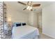 Bedroom featuring a bed with a white quilt and blue pillows, side table, and ceiling fan at 11474 Rolling Green Dr, Bradenton, FL 34211