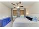 Bedroom featuring a white quilt, blue decorative pillows, and a bright blue cabinet at 11474 Rolling Green Dr, Bradenton, FL 34211