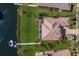 Aerial view of backyard featuring a patio, pool and private dock on the canal with a boat lift at 11739 River Shores Trl, Parrish, FL 34219