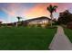 Expansive backyard featuring lush lawn, screened lanai, and mature trees at sunset at 11739 River Shores Trl, Parrish, FL 34219