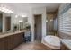 Luxurious bathroom showcasing a large soaking tub, walk-in shower, and granite countertops, providing a tranquil retreat at 11739 River Shores Trl, Parrish, FL 34219