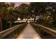 Scenic boardwalk leading to the lake, surrounded by palm trees and greenery at 11739 River Shores Trl, Parrish, FL 34219