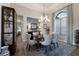 Formal dining room featuring a large window and elegant chandelier at 11739 River Shores Trl, Parrish, FL 34219