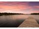 Beautiful lake view from a wooden dock with a bridge in the background at 11739 River Shores Trl, Parrish, FL 34219