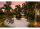 Outdoor firepit surrounded by rocking chairs and lush greenery at 11739 River Shores Trl, Parrish, FL 34219