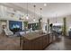 Open concept kitchen with granite island, stainless appliances, and adjacent living and dining areas, ideal for entertaining at 11739 River Shores Trl, Parrish, FL 34219