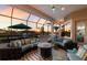 Covered outdoor living area with comfortable seating overlooking a waterfront view and a colorful sunset at 11739 River Shores Trl, Parrish, FL 34219