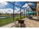 Relaxing screened-in patio with brick flooring, outdoor seating, and a serene view of the water at 11739 River Shores Trl, Parrish, FL 34219