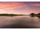 Calm waterfront view showcasing the serene atmosphere and sunset skies at 11739 River Shores Trl, Parrish, FL 34219