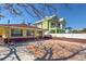 Rear of house with red brick foundation and shade provided by a beautiful mature tree at 118 9Th N St, Bradenton Beach, FL 34217