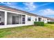 Backyard with covered patio, offering a great outdoor living space and green landscaping at 11831 Brookside Dr, Bradenton, FL 34211