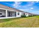 A sprawling backyard with white enclosed patios and great outdoor space for activities at 11831 Brookside Dr, Bradenton, FL 34211