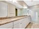 Bathroom with a double vanity, granite countertops, and walk-in shower at 11831 Brookside Dr, Bradenton, FL 34211
