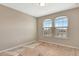 An unfinished bedroom space featuring neutral paint, two windows, and natural light at 11831 Brookside Dr, Bradenton, FL 34211