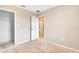 An unfinished bedroom space featuring neutral paint, white trim, and two interior doors at 11831 Brookside Dr, Bradenton, FL 34211