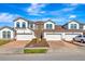 Charming townhome featuring a two-car garage, brick-paved driveway, and well-maintained landscaping at 11831 Brookside Dr, Bradenton, FL 34211