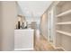 Open-concept floor plan with modern finishes, wood-look tile flooring, and a view of the staircase at 11831 Brookside Dr, Bradenton, FL 34211