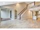 Bright living room featuring an open floor plan, a staircase, and access to a sunroom at 11831 Brookside Dr, Bradenton, FL 34211
