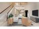 Bright living room featuring a staircase, high ceilings and an open concept kitchen at 11831 Brookside Dr, Bradenton, FL 34211