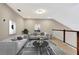Modern loft featuring neutral paint, lots of natural light, and plush grey couches at 11831 Brookside Dr, Bradenton, FL 34211