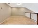 An unfinished loft space featuring neutral paint, natural light, and dark-stained wood railings at 11831 Brookside Dr, Bradenton, FL 34211
