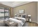 Spacious bedroom with a sliding glass door, neutral tones, and ample natural light at 11831 Brookside Dr, Bradenton, FL 34211