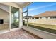 Enclosed brick patio showcases a serene view of the backyard, offering a relaxing space to unwind at 11831 Brookside Dr, Bradenton, FL 34211