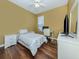 Cozy bedroom with a single bed, a desk with a computer and wood flooring at 12022 Granite Woods Loop, Venice, FL 34292