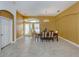 Inviting dining room with tile floors, a modern chandelier, and a view of the front entrance at 12022 Granite Woods Loop, Venice, FL 34292
