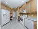 A view of the kitchen, showing the appliances, tile flooring, and breakfast nook at 12022 Granite Woods Loop, Venice, FL 34292